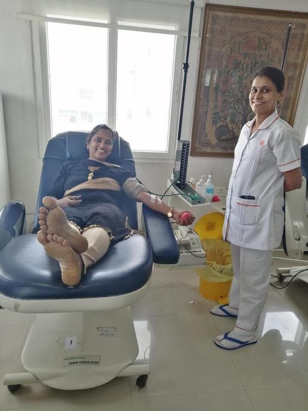 A TechieRide member donating blood at a licensed blood bank donor station, attended by nursing staff